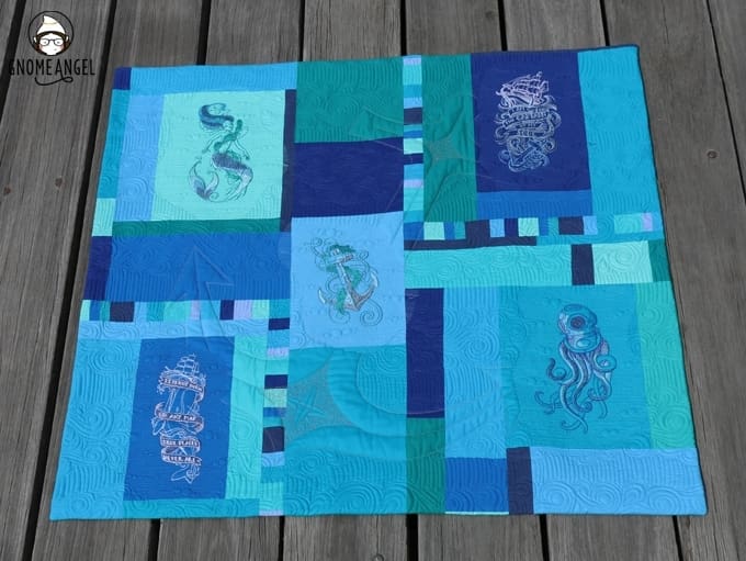 "Son of a Son of a Sailor" - Designed, embroidered and pieced by Angie Wilson of www.GnomeAngel.com using Robert Kaufman Kona and Urban Threads Embroidery Patterns. Custom quilted by Raylee Bielenberg of Sunflower Quilting | Find out more at www.GnomeAngel.com