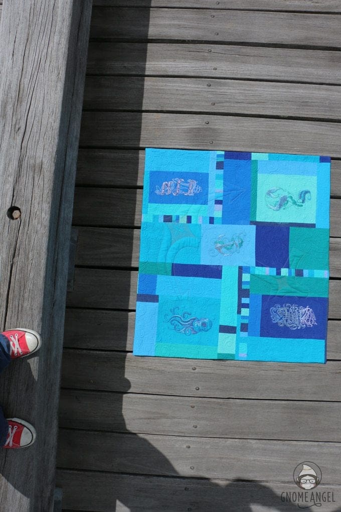 "Son of a Son of a Sailor" - Designed, embroidered and pieced by Angie Wilson of www.GnomeAngel.com using Robert Kaufman Kona and Urban Threads Embroidery Patterns. Custom quilted by Raylee Bielenberg of Sunflower Quilting | Find out more at www.GnomeAngel.com