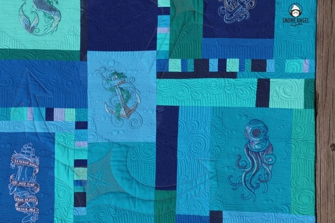 "Son of a Son of a Sailor" - Designed, embroidered and pieced by Angie Wilson of www.GnomeAngel.com using Robert Kaufman Kona and Urban Threads Embroidery Patterns. Custom quilted by Raylee Bielenberg of Sunflower Quilting | Find out more at www.GnomeAngel.com