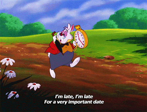 White rabbit from Disney's Alice in Wonderland running down a path with his pocket watch out saying "I'm late. I'm late."